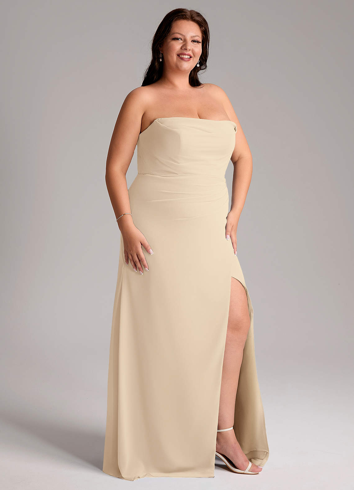 azazie champagne bridesmaid dresses Leonis line skirt paired with a leg slit. Azazie Clarice