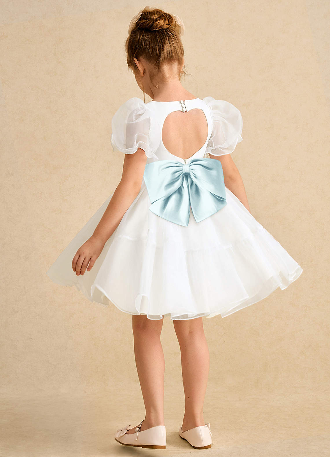 glass organza dress A teal-blue glass tissue organza gown, cut with sculptural off-shoulder draping and fluid, light-catching pleats. Weightless yet commanding, it glows against the city at dusk a study in modern elegance and
